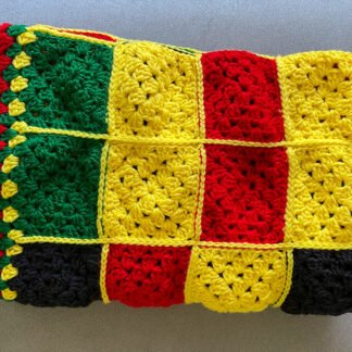 red, black, yellow granny square blanket folded in half 3 times