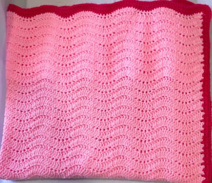 Pink-Raspberry-Feather-and-Fan-Crochet-Blanket-folded-in-half-twice.